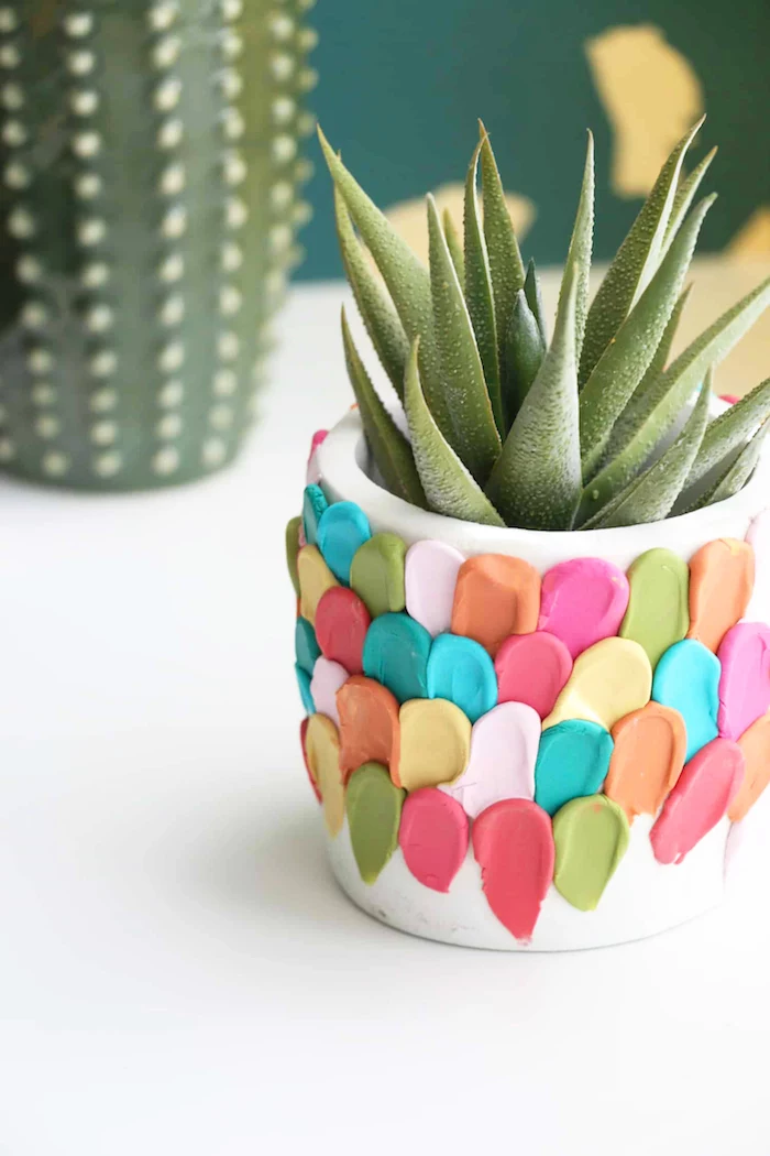 white ceramic pot, decorated with parts of colorful clay around it, best friend gifts diy, succulent growing inside