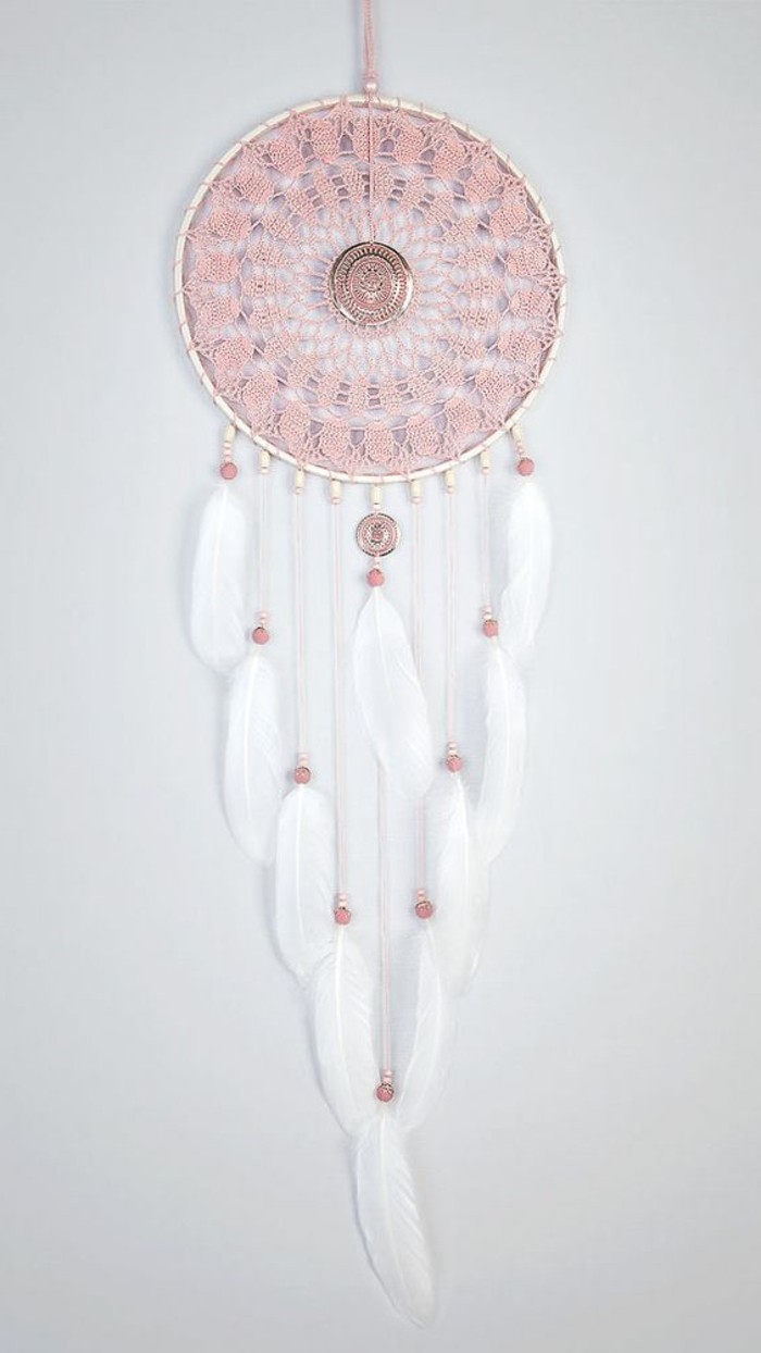 doily-like pink crochet detail, on a large dream catcher, with white feathers, and pink beads