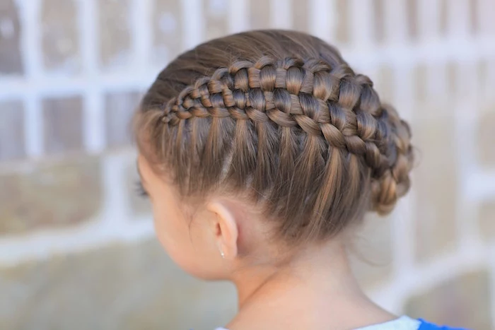cute hairstyles, close up of a complex braided up-do, on the head of a brunette child, seen from the back