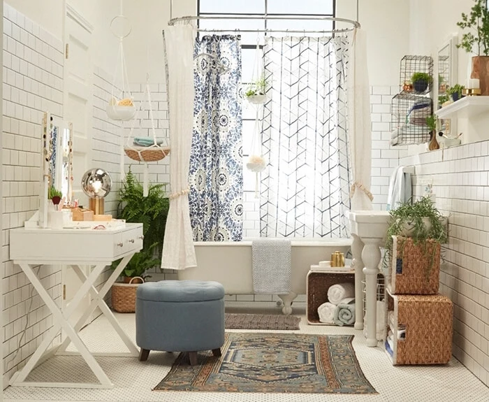 subway tiles in white, on the walls of a bright room, decorated with potted plants, and several shower curtains, rugs and white furniture, bathroom decorating ideas on a budget 