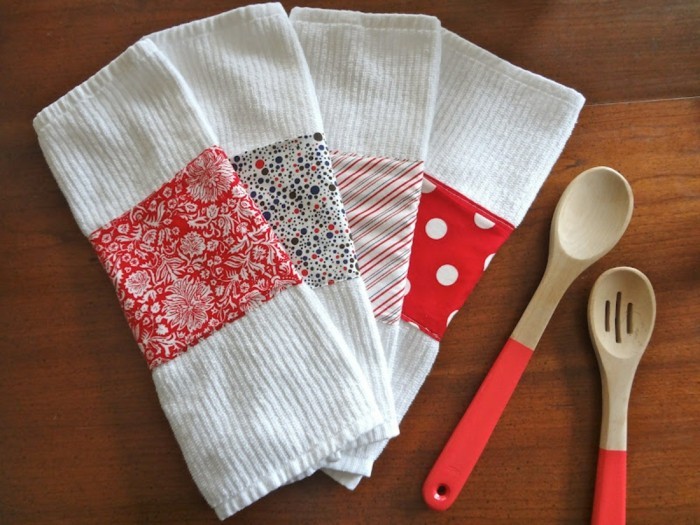 towels in white, decorated with patterned pieces of fabric, in red and white, cute birthday ideas, two wooden spoons with red handles