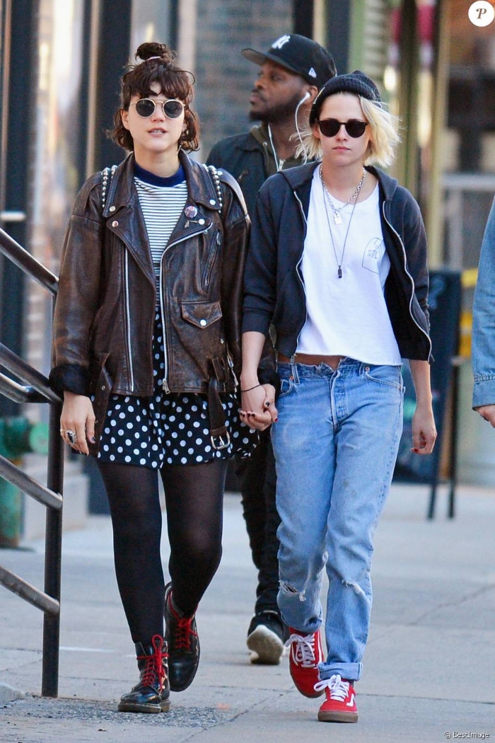 bomber jacket in black, over white t-shirt, and unbuttoned baggy jeans, brown studded leather jacket, with striped top, and polka-dot skirt, worn by kristen stewart and her girlfriend