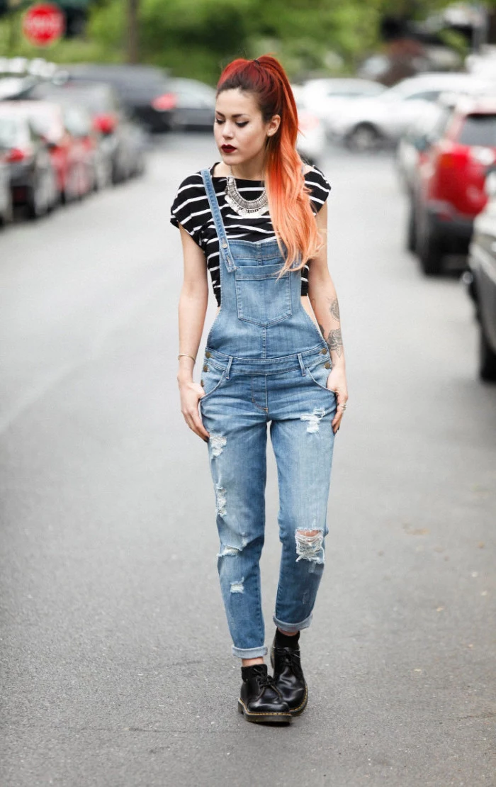 chunky silver necklace, worn with a striped, black and white t-shirt, and ripped 90s overalls, by young woman with dyed hair