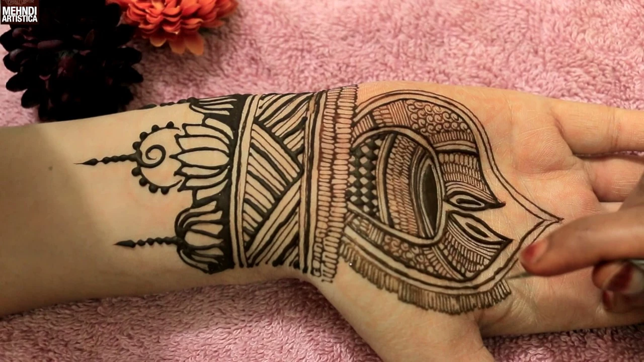 muslim henna hand tattoo designs, black lotus-like shapes, painted on a person's wrist and palm