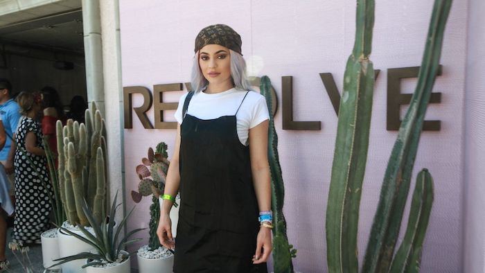 headscarf with luis vuitton pattern, worn by kylie jenner, in a black strappy dress, and a white t-shirt