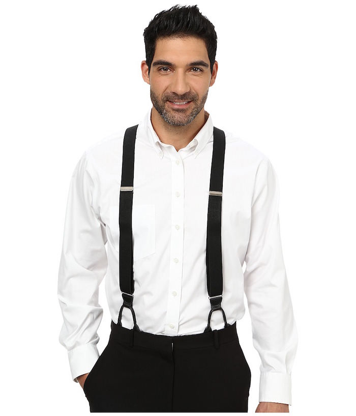 20s mens fashion, suspenders in black, a white shirt, and black trousers, worn by a smiling man, with stubble on his face, and one hand in his pocket