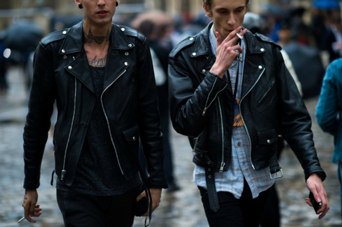smoking man wearing a black, leather biker jacket, over a pale blue checkered shirt, and black trousers, 90s halloween costumes, man in a similar outfit, walking next to him