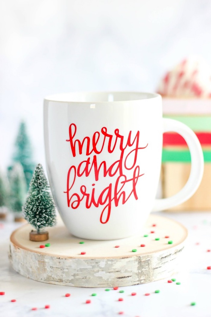creative gift ideas, merry and bright christmas coffee mug, placed on wooden log, small faux toy tree next to it