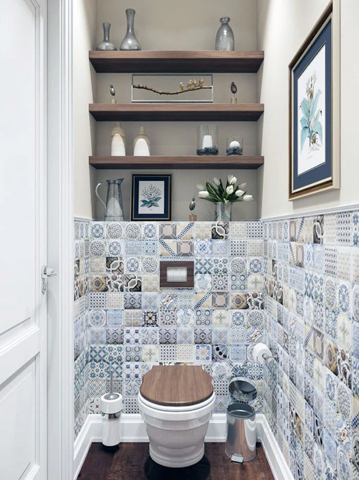 small bathroom décor, patchwork of multicolored moroccan tiles, with different patterns, in a narrow room, with a toilet, and three shelves
