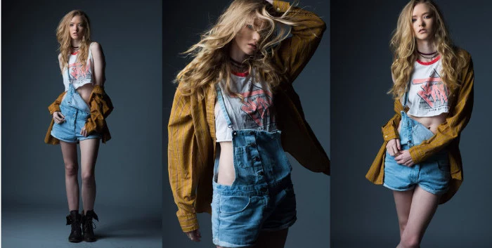 three images of a blonde young woman, wearing short denim overalls, a bulky yellow jacket, and a cropped retro t-shirt, 90s aesthetic