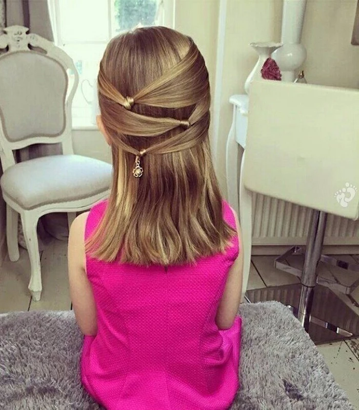 fuchsia pink formal sleeveless dress, worn by a young girl, with wavy honey blonde hair, decorated with knotted details, girl haircuts, medium length style