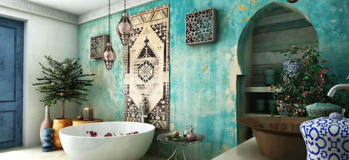 unevenly painted turquoise accent wall, inside a moroccan-style bathroom, containing a round bathtub, a small indoor tree, and lots of decorative items