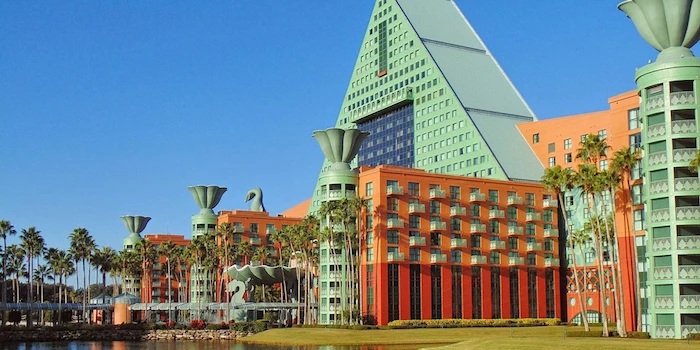 modernism and postmodernism, disney resort's swan hotel, in yellow and green, with a pyramid shape, and column-like structures, decorated with floral motifs