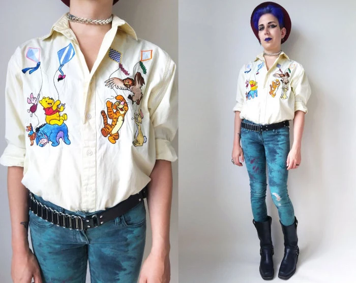winnie-the-pooh characters embroidered on a pale yellow shirt, worn by a woman with violet hair, wearing violet lipstick, 90s halloween costumes, black boots and skinny jeans, decorated with paint, 90s retro jumper outfit