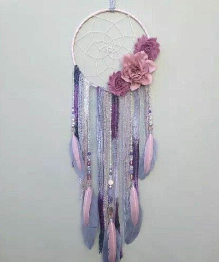 three pink flower ornaments, attached to a white dreamcatcher, pictures of dream catchers, with pastel pink, violet and purple tassels and feathers