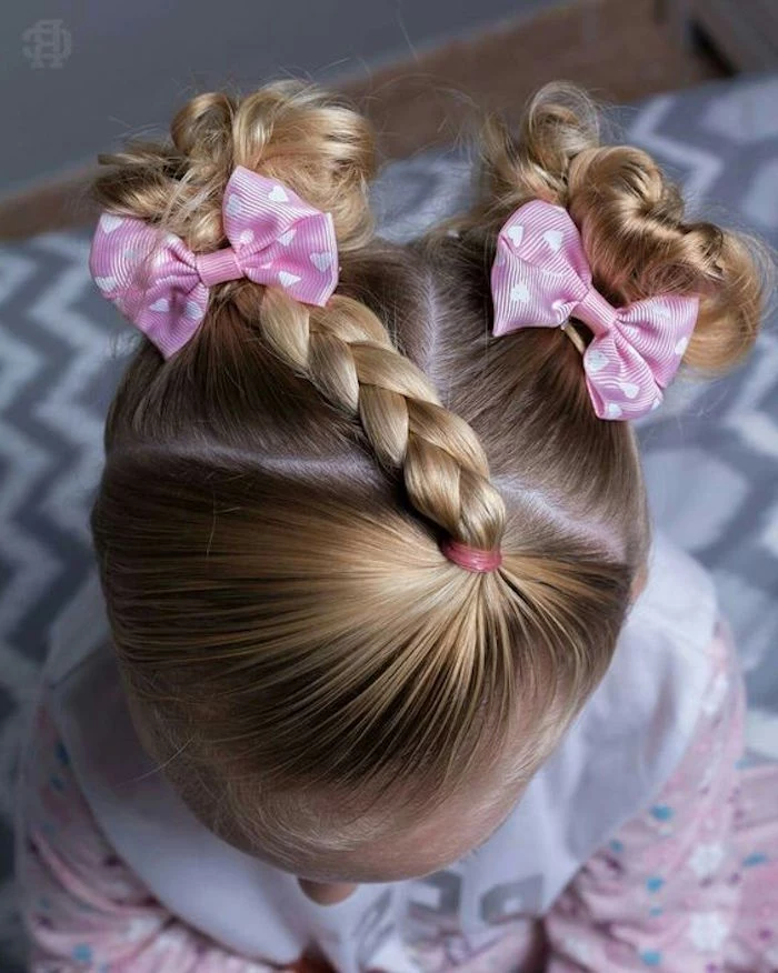 side-braid and two small, curled pigtails with bows, cute hairstyles, on the head of a small girl