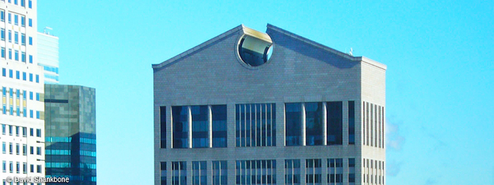 gabled roof with a hole detail, on top of a skyscraper, with windows in different shapes, the sony tower in new york