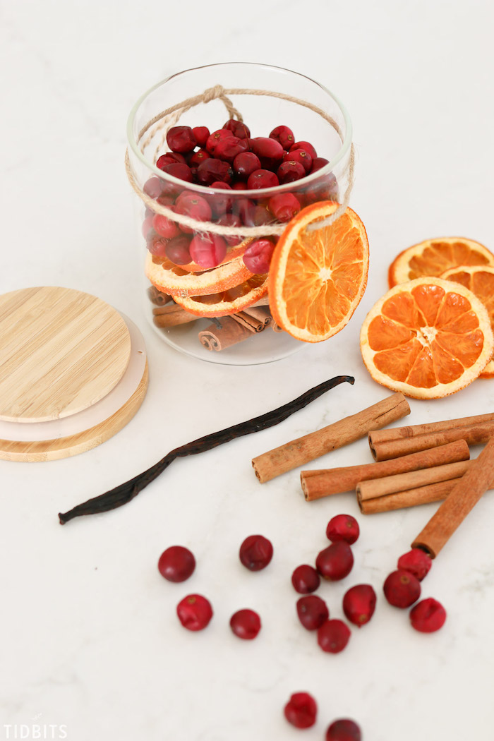 potpourri in a glass jar, made with dried orange slices and cranberries, cinnamon and vanilla sticks, diy christmas gifts