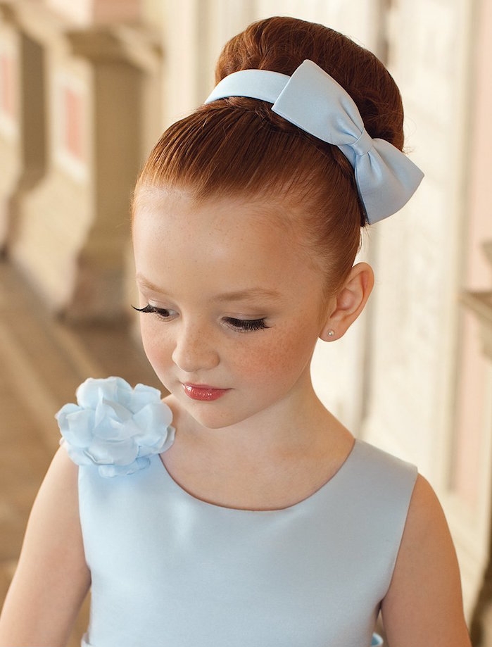 smooth large bun, decorated with a pale blue bow, hairstyles for little girls, red-haired child, in a pale blue formal dress