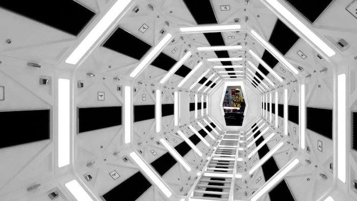 2001: a space odyssey, hexagonal tunnel in black and white, with glowing white fluorescent lights, impressive movie set designs