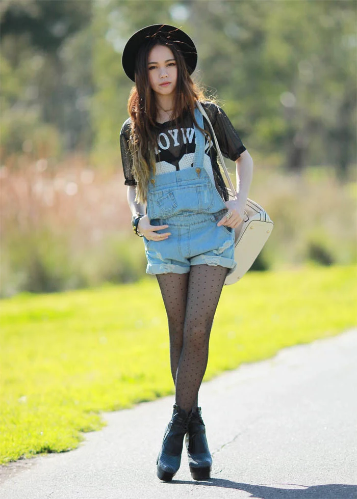 polka dots on sheer black tights, worn with a sports t-shirt, and short baggy denim overalls