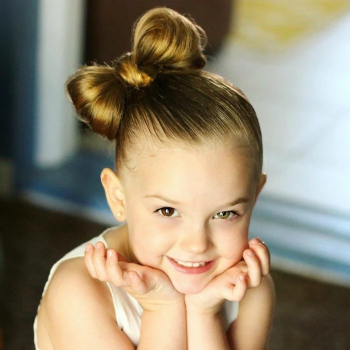 bow-shaped braid, on the side of a child's head, little girl haircuts, one of the child's eyes is brown, and the other green