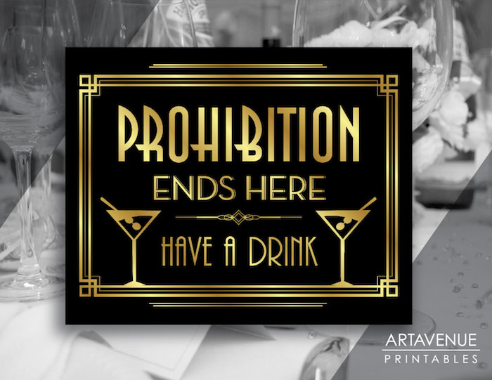 prohibition ends here, have a drink, written in gold letters, on a black art deco sign, with two drawings, of cocktail glasses