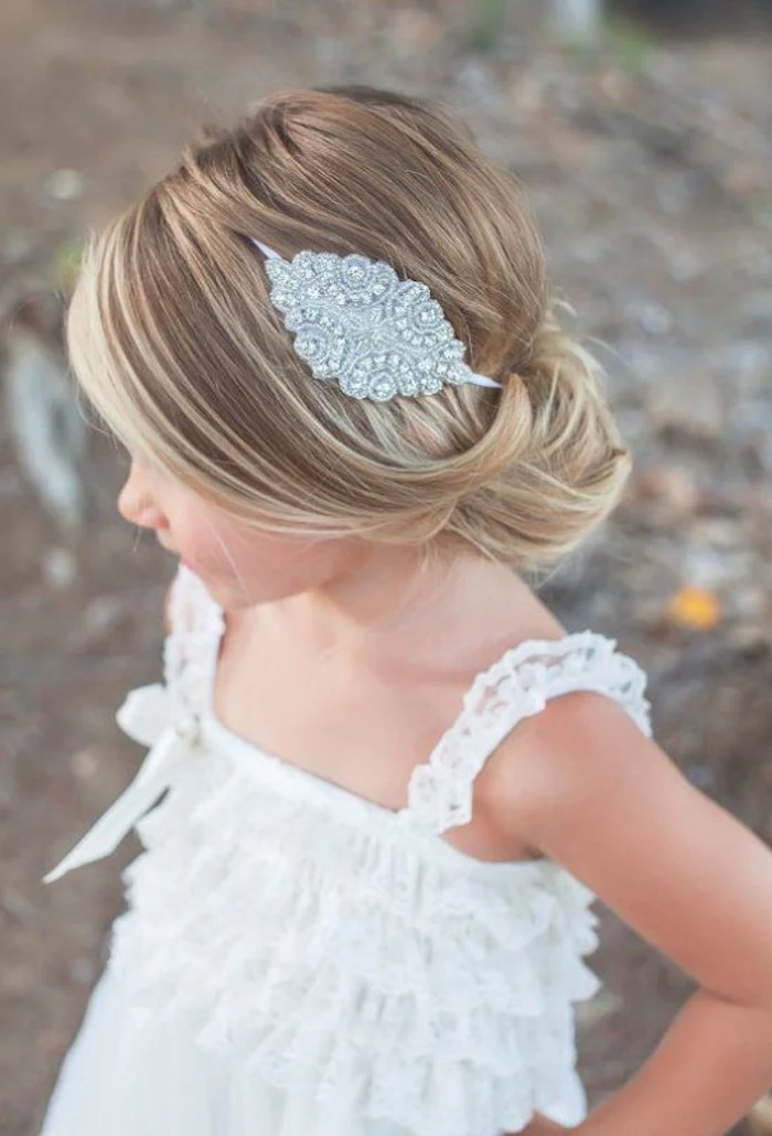 simple hairstyles, silver hair ornament, with diamante details, decorating the smooth, dark blonde hair, of a small child, white frilly lace top, natural highlights