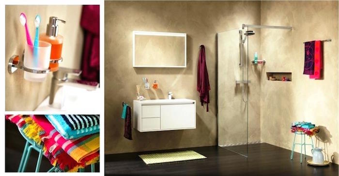 fabrics in colorful patterns, toothbrushes in popping colors, and vibrant towels, in a minimalistic room with beige wash walls, containing a shower, and a white cupboard, with inbuilt sink