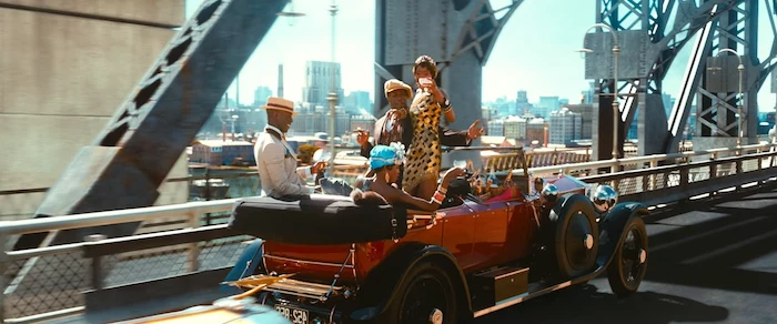 red antique car, speeding on a bridge, inside are a group of black youths, drinking champagne and partying, dressed in roaring 20s fashion