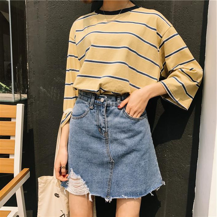yellow striped top, with 3/4 sleeves, worn tucked into a high waisted denim skirt, with ripped detail, 90s clothes womens