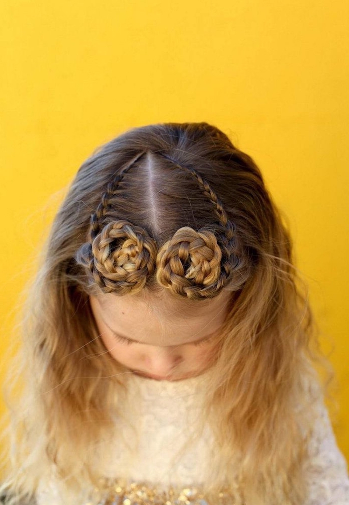 round braided swirls, on the top of a small child's head, little girl hairstyles, seen from a high angle