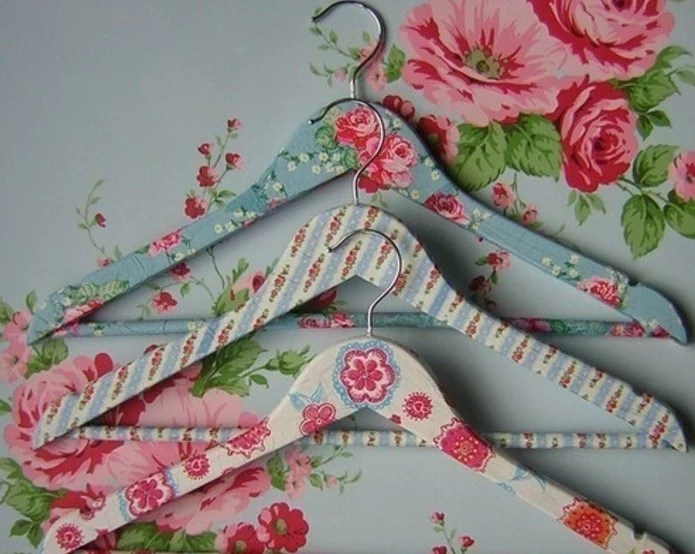 floral decoupage in pink, blue and cream, decorating a set of three wooden hangers, inexpensive thank you gift ideas