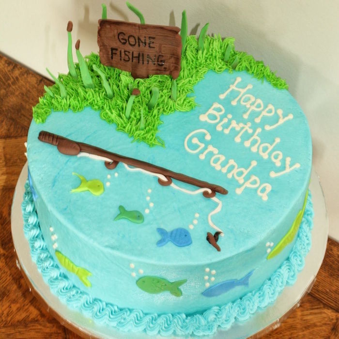 teal round cake, decorated with a fishing rod, several small fish shapes, green grass and a brown sign, with the inscription gone fishing, all made from colorful fondant, happy 60th birthday, cake ideas for grandpa