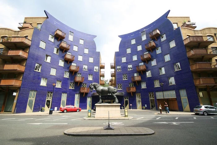 postmodernism characteristics, purple and beige symmetrical buildings, with square windows, and terraces with brown railings