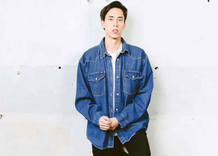 90s party outfits for guys, oversized inky blue denim shirt, worn with a plain white tee, and black skinny trousers