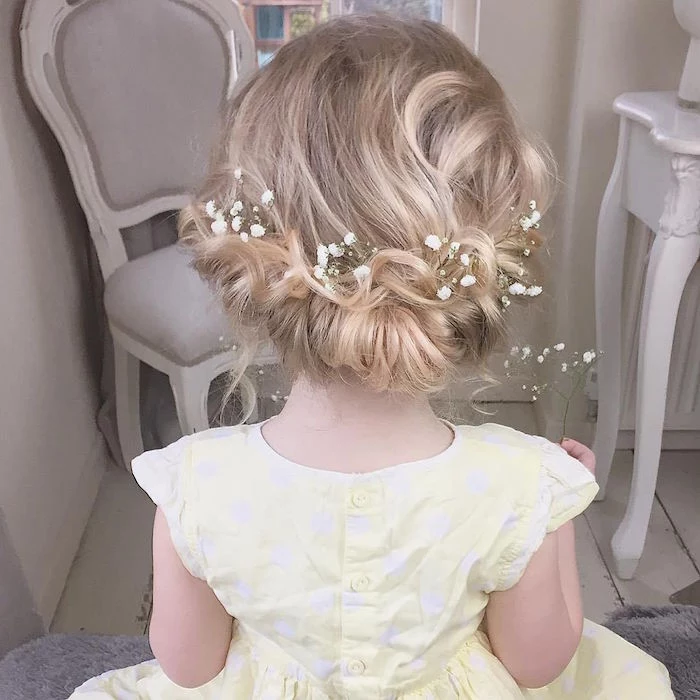 tiny white flowers, decorating the hair of a little girl, cute hairstyles, fancy wedding up-do for a flower girl, blonde hair with natural highlights