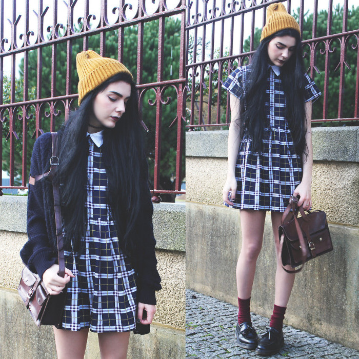 beanie hat in yellow, worn by black-haired young woman, in a plaid mini dress, with peter pan collar, 90s clothes womens, leather satchel bag