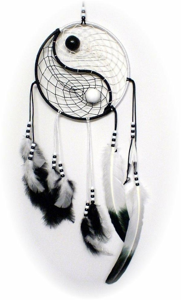 monochrome dream catcher, with white and black feathers, matching two-tone beads, and a yin and yang motif