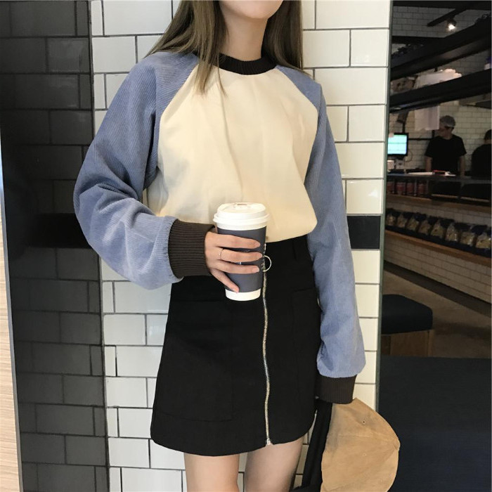 paper coffee cup, held by a brunette woman, in a black zip front miniskirt, 90s themed outfits, cream and grey retro sweater