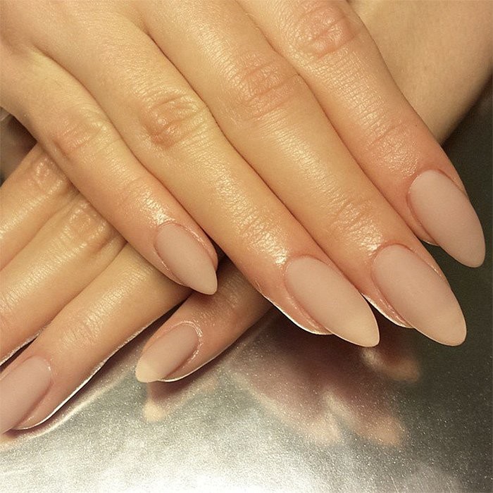 matte nail polish in nude, pinky beige, on two hands, with long fingers, and almond shaped manicure