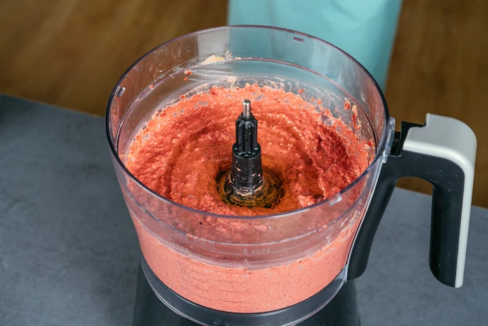 beetroot hummus mixed in a blender, beet hummus recipe, placed on black surface