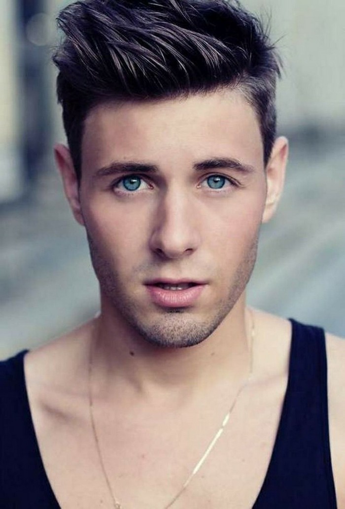 short sides long top haircut, on young man with blue eyes, wearing a black tank top