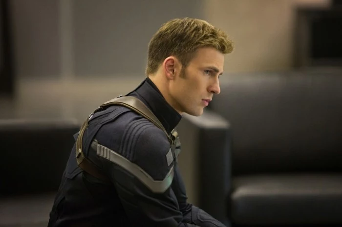 chris evans as captain america, in a black and grey suit, with cropped blonde hair, modern haircuts for men, crew cut style