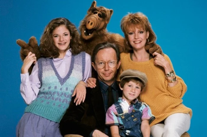 alf actors posing together, dressed in vinatge clothes, 80s fashion trends, knitted sweater and vest, smart suit and dungerees, typical 80s fashion