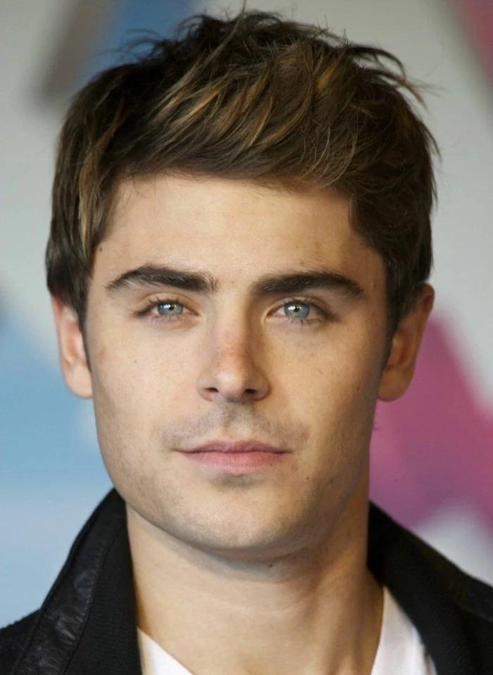 zac efron with brunette hair, featuring subtle highlights, and styled in a quiff, short guy haircuts