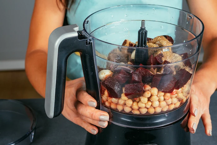 chickpeas and beetroot, all ingredients placed in a blender, beet hummus recipe, placed on black surface