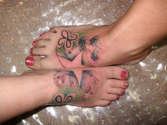 star shape formed by two foot tattoos, when they are pressed together, matching sister tattoos, with small stars and butterfly-like motifs
