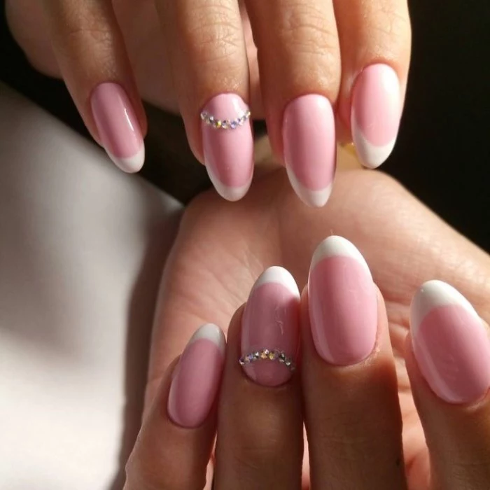 acrylic nail shapes, on two hands, with french manicure, both ring finger nails are decorated with rhinestones