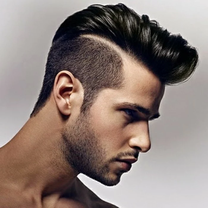 pompadour with a disconnected undercut, worn by a black-haired man, types of haircuts for men, with stubble on his chin and upper lip
